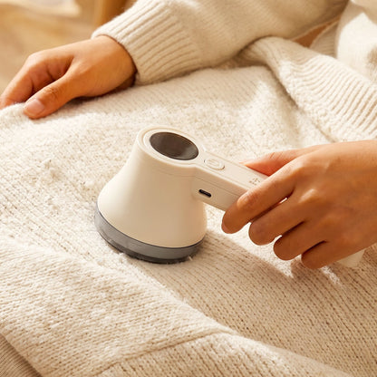Lint Remover in Use on Sweater